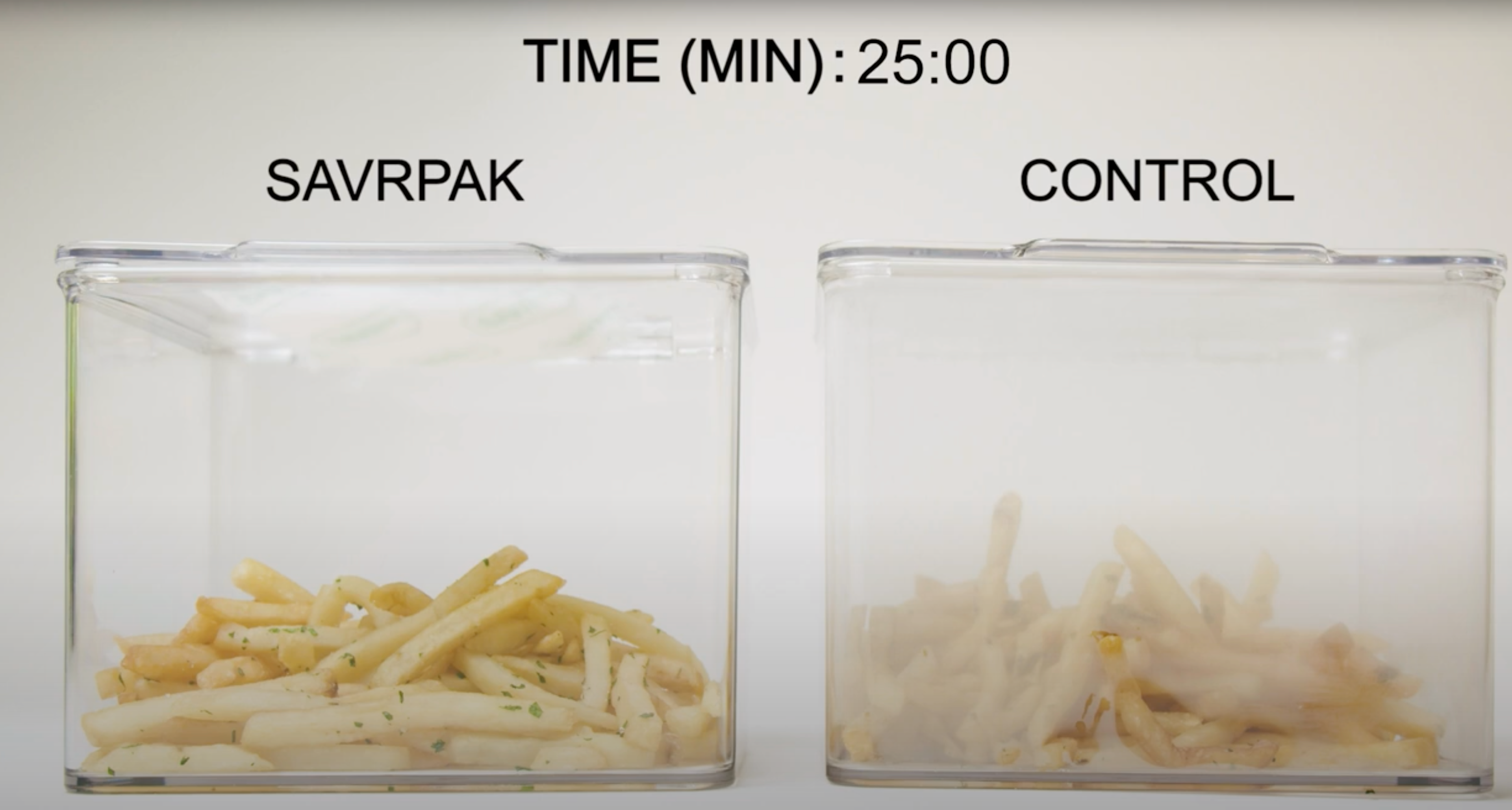 A still from a SAVRPak demo video shows that, after 25 minutes, one clear container containing french fries and fitted with a SAVRPak pad is clear, while another clear container containing fries and no SAVRPak pad is all fogged up.  