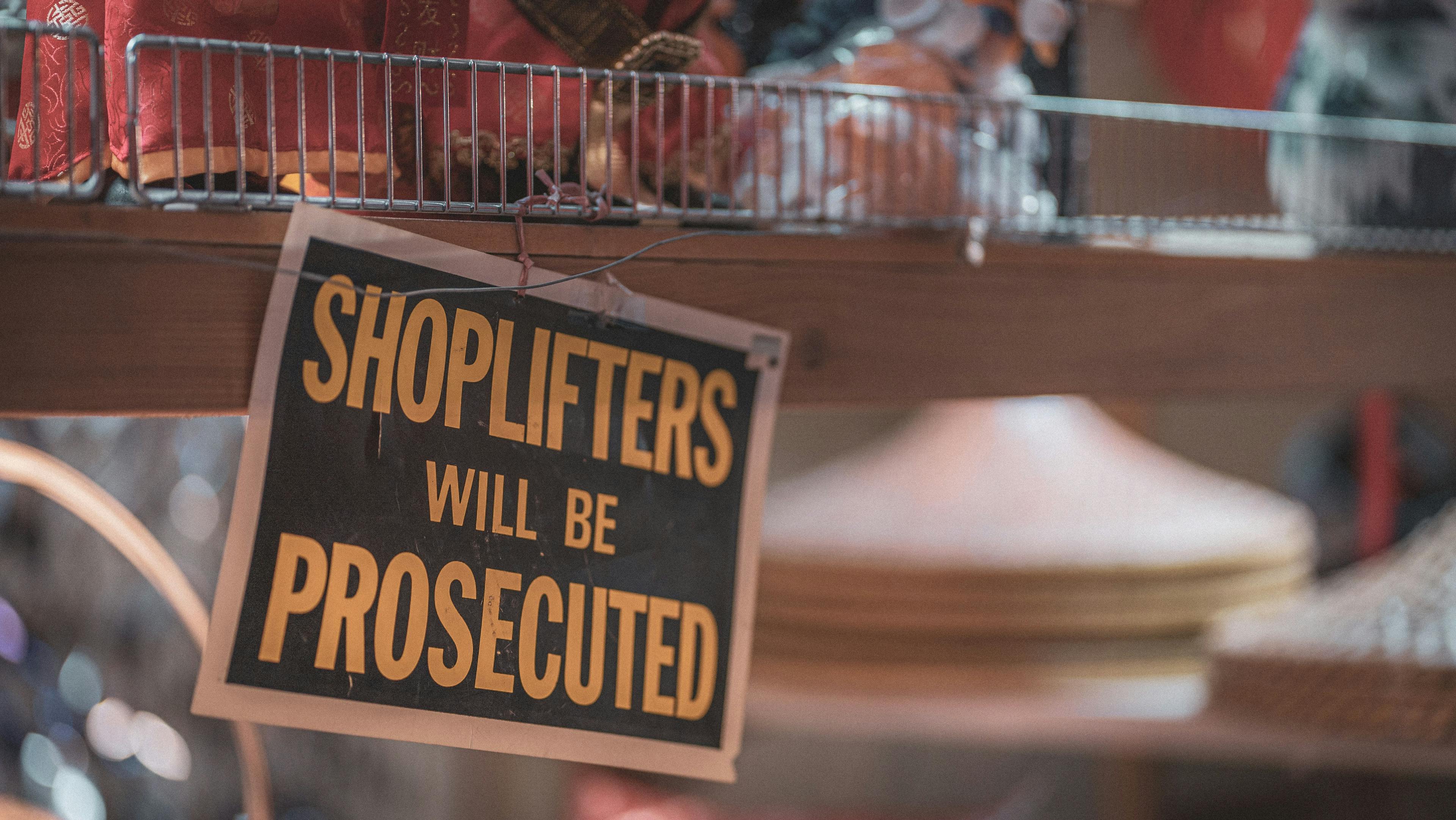 A sign in a store that says, "Shoplifters will be prosecuted."