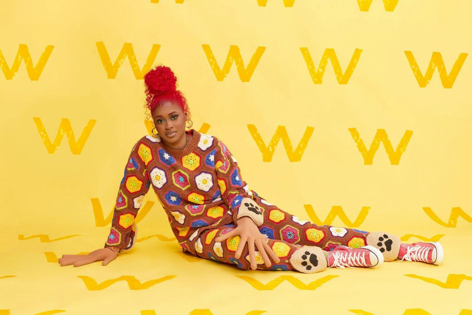 Tierra Whack poses in her crocheted onesie that's now available to rent or own on Nuuly. 