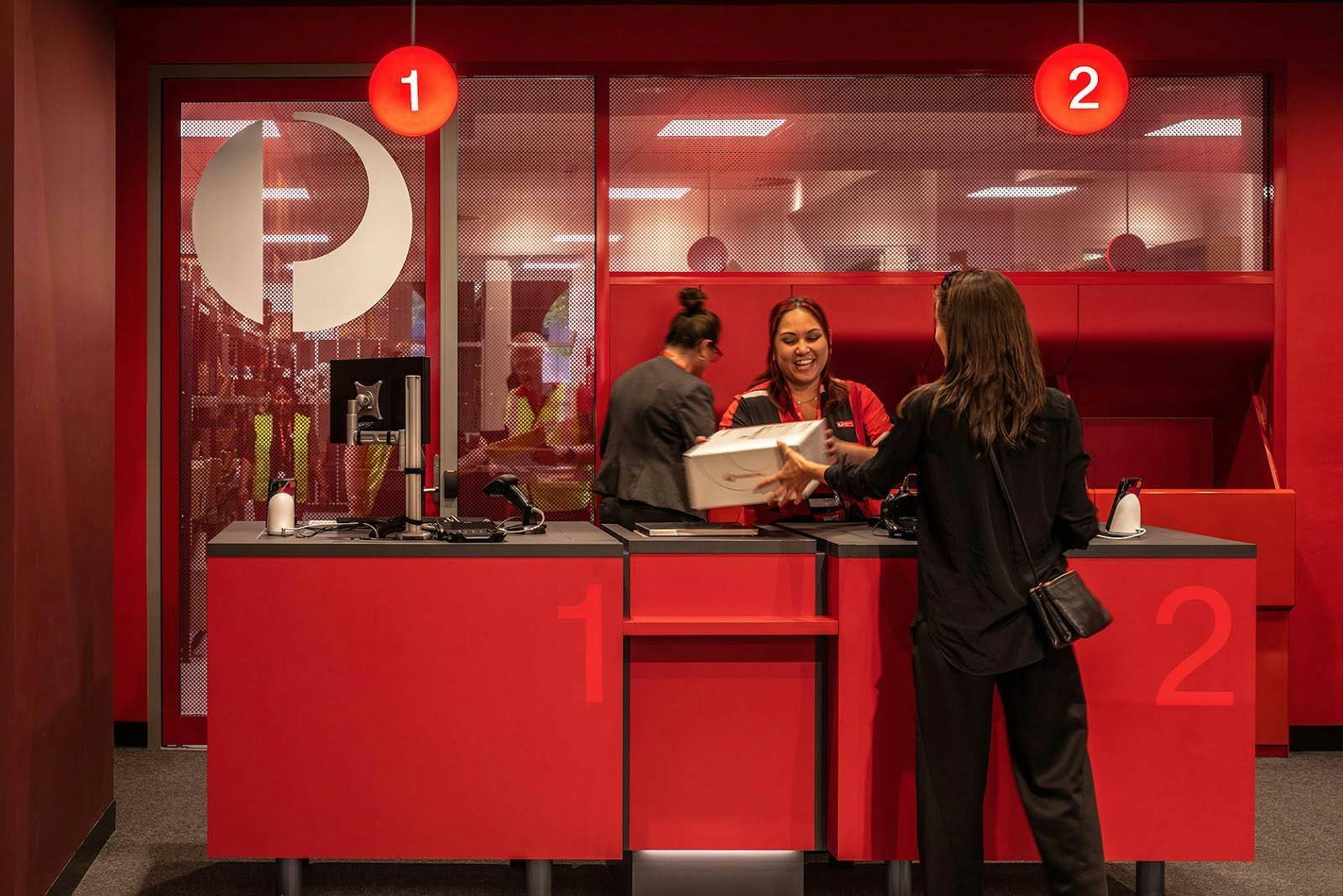 A customer is helped at a counter in Australia Post's newly designed post office in Orange, New South Wales.