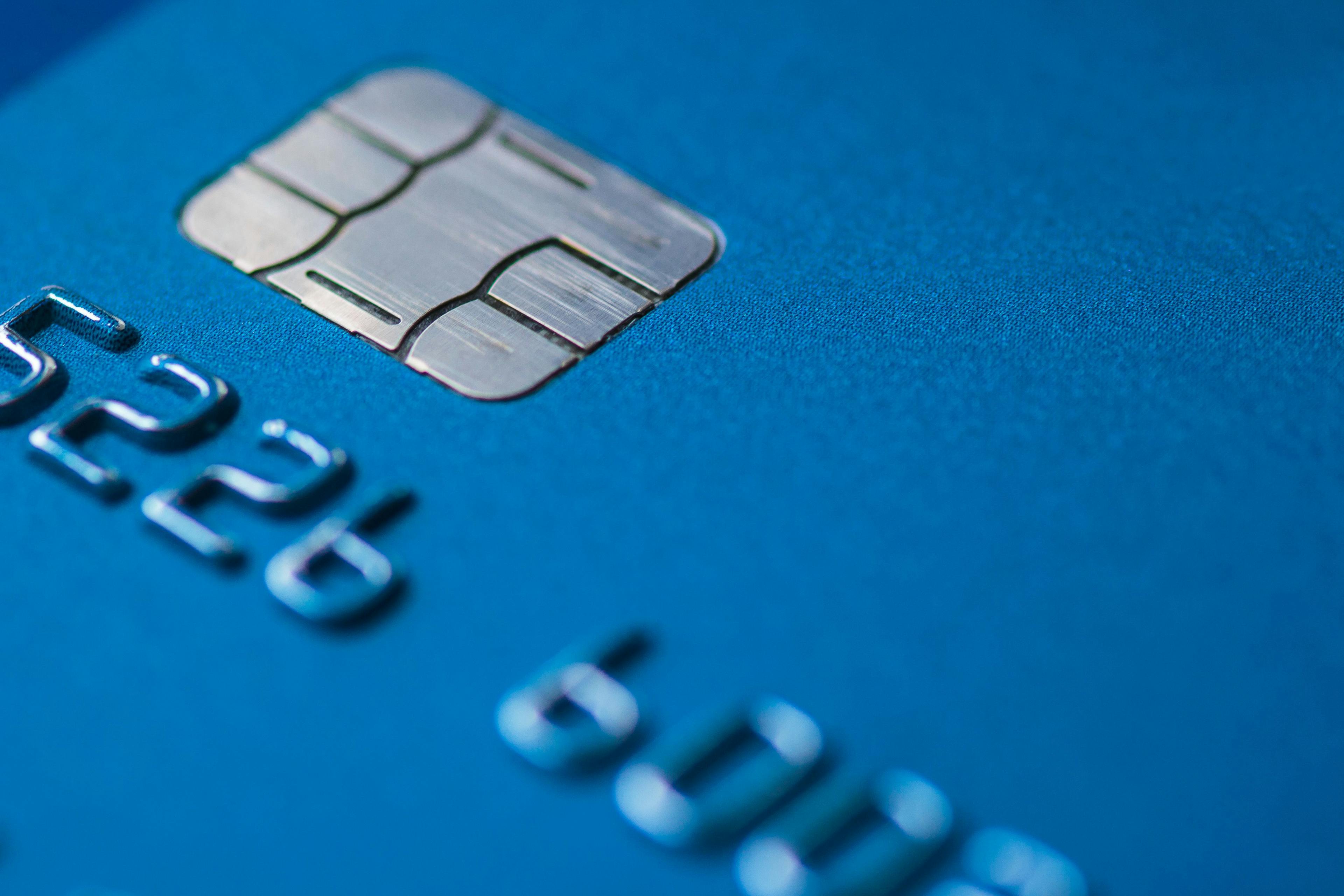 A close-up photograph of a credit card that focuses primarily on the chip embedded in the front. 
