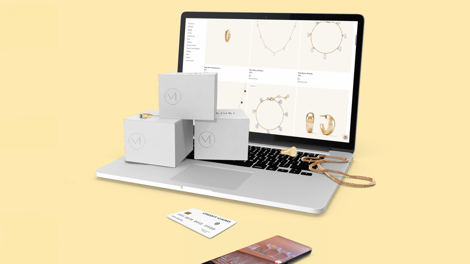 Laptop with Mejuri jewelry boxes credit card and phone with TikTok